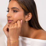 Lavana Signature Gold Diamond Studs on model iconic diamond logo stud earrings