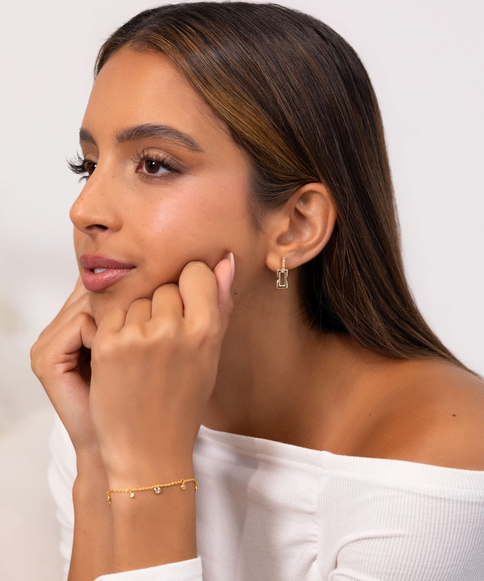 Lavana Signature Gold Diamond Studs on model iconic diamond logo stud earrings