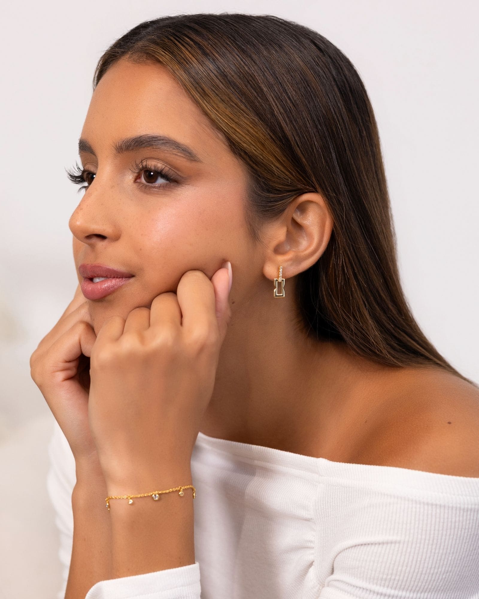 Lavana Signature Gold Diamond Studs on model iconic diamond logo stud earrings