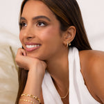 Lavana Signature Gold Studs on model iconic logo stud earrings