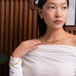 Lavana Signature gold diamond bangle, on model; with logo motif modern links and lab grown diamonds