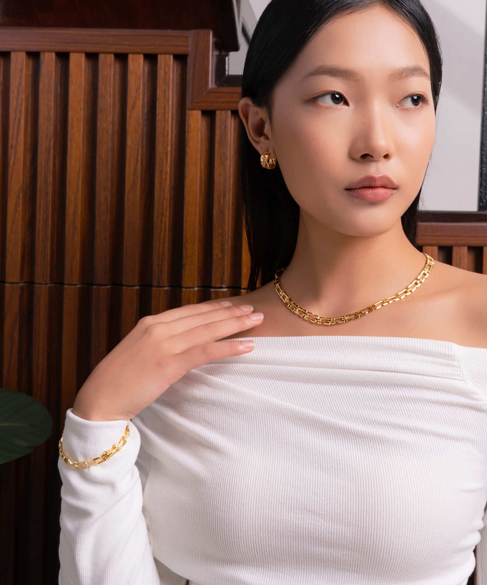 Lavana Signature gold diamond bangle, on model; with logo motif modern links and lab grown diamonds