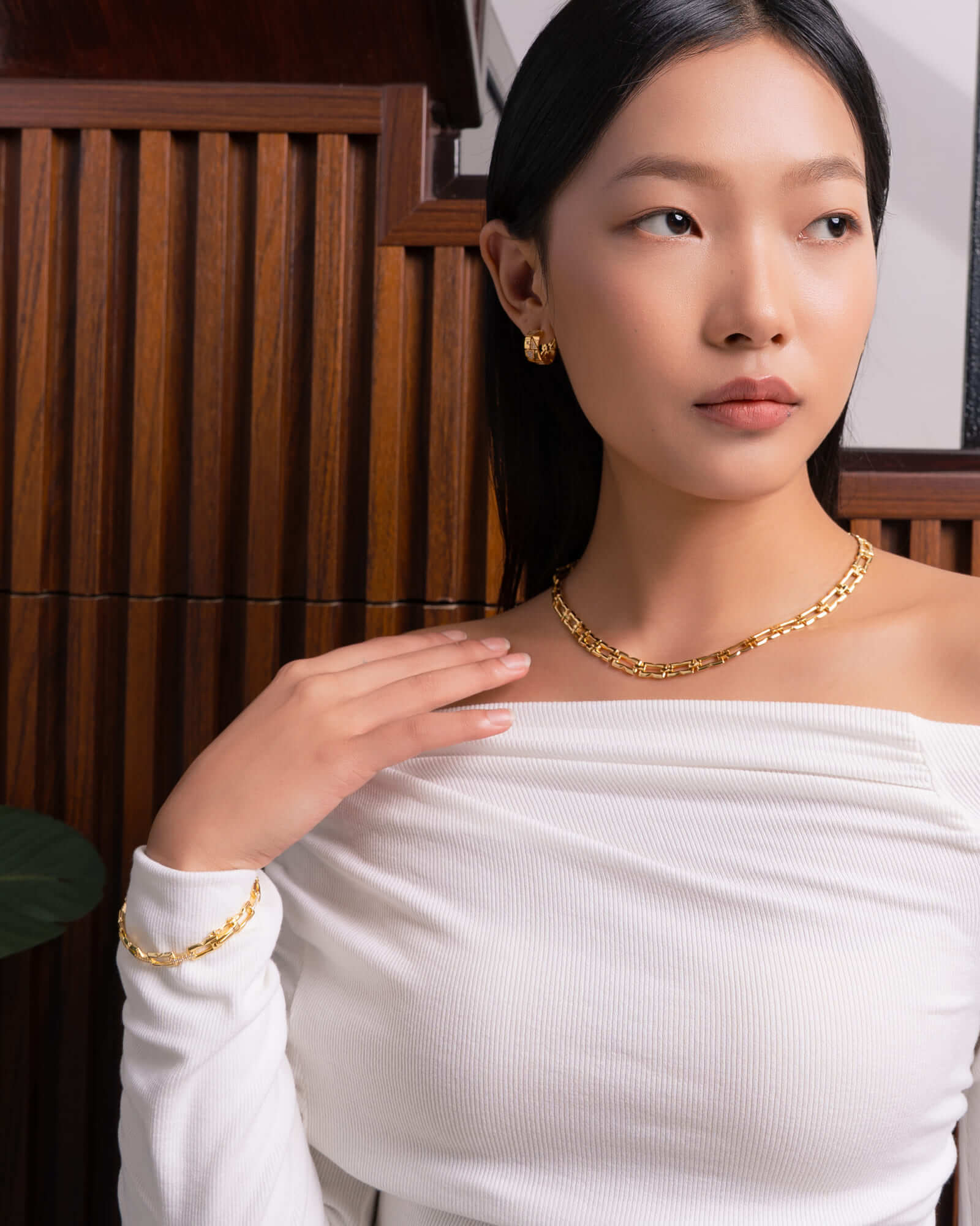 Lavana Signature gold diamond bangle, on model; with logo motif modern links and lab grown diamonds