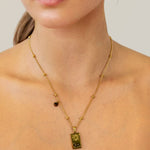 Leo Gold Zodiac Tag Necklace by Lavana, on model; engraved tag with constellation on beaded chain, back
