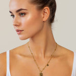 Leo Gold Zodiac Tag Necklace by Lavana, on model; engraved tag with constellation on beaded chain, front 