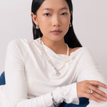 Liquid Arc Silver Earrings by Lavana, on model; modern polished tapered arc with mirror shine