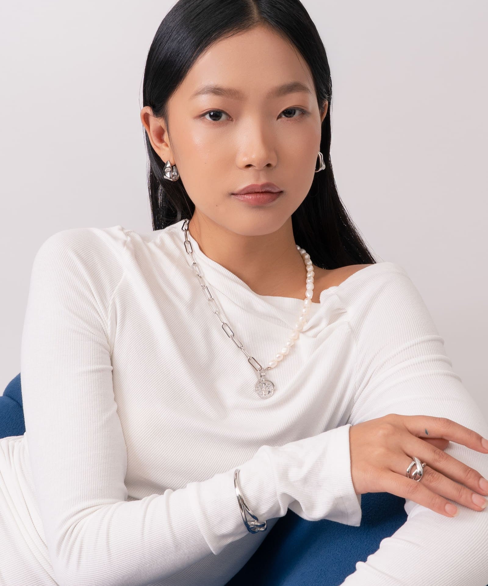 Liquid Arc Silver Earrings by Lavana, on model; modern polished tapered arc with mirror shine