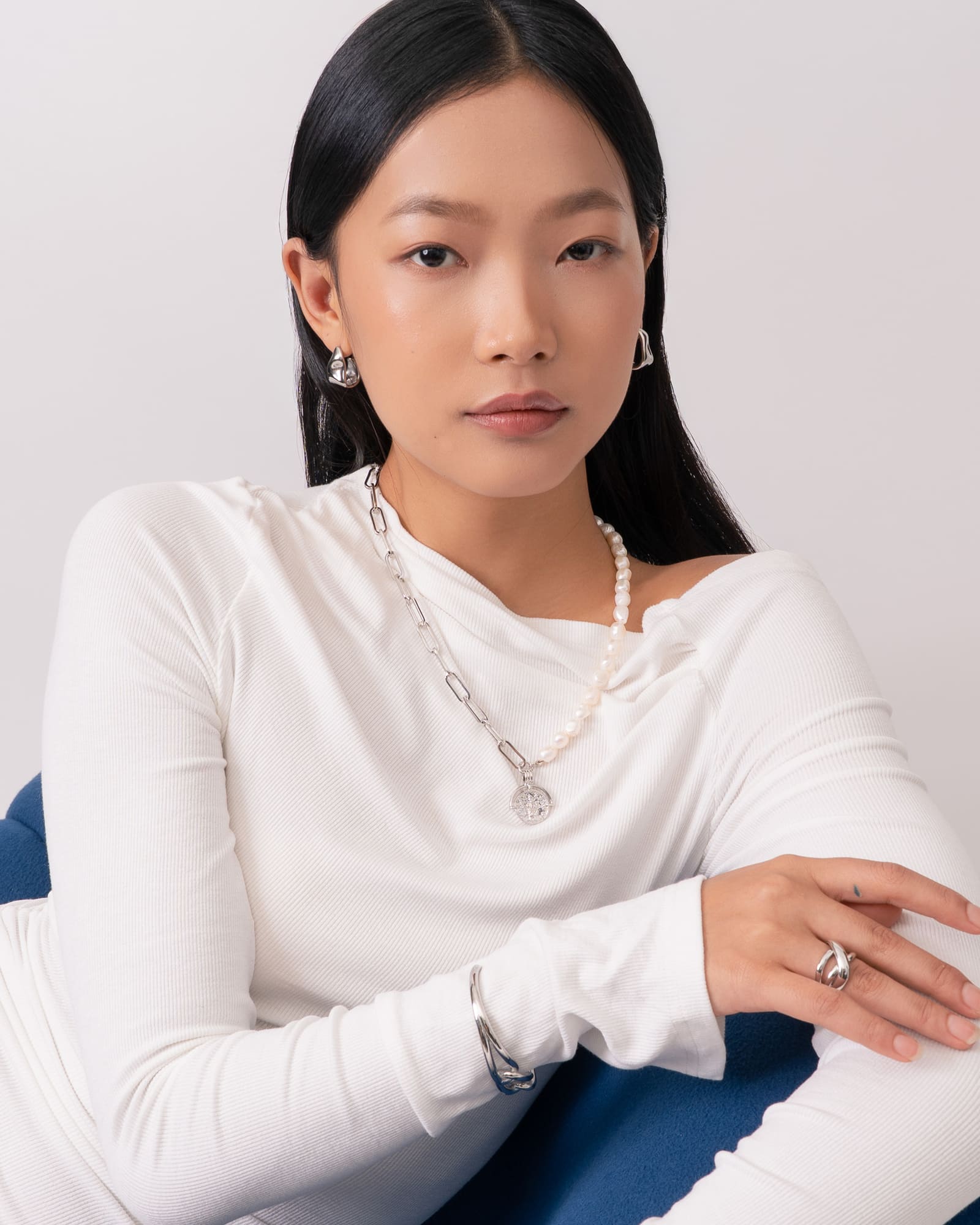 Liquid Arc Silver Earrings by Lavana, on model; modern polished tapered arc with mirror shine