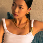 Luna Gold L Hoop Earrings by Lavana, on model; polished classic 4mm dress hoops available in four sizes