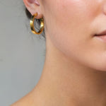 Luna Gold Large Hoop Earrings by Lavana on model polished classic 4mm hoops available in four sizes