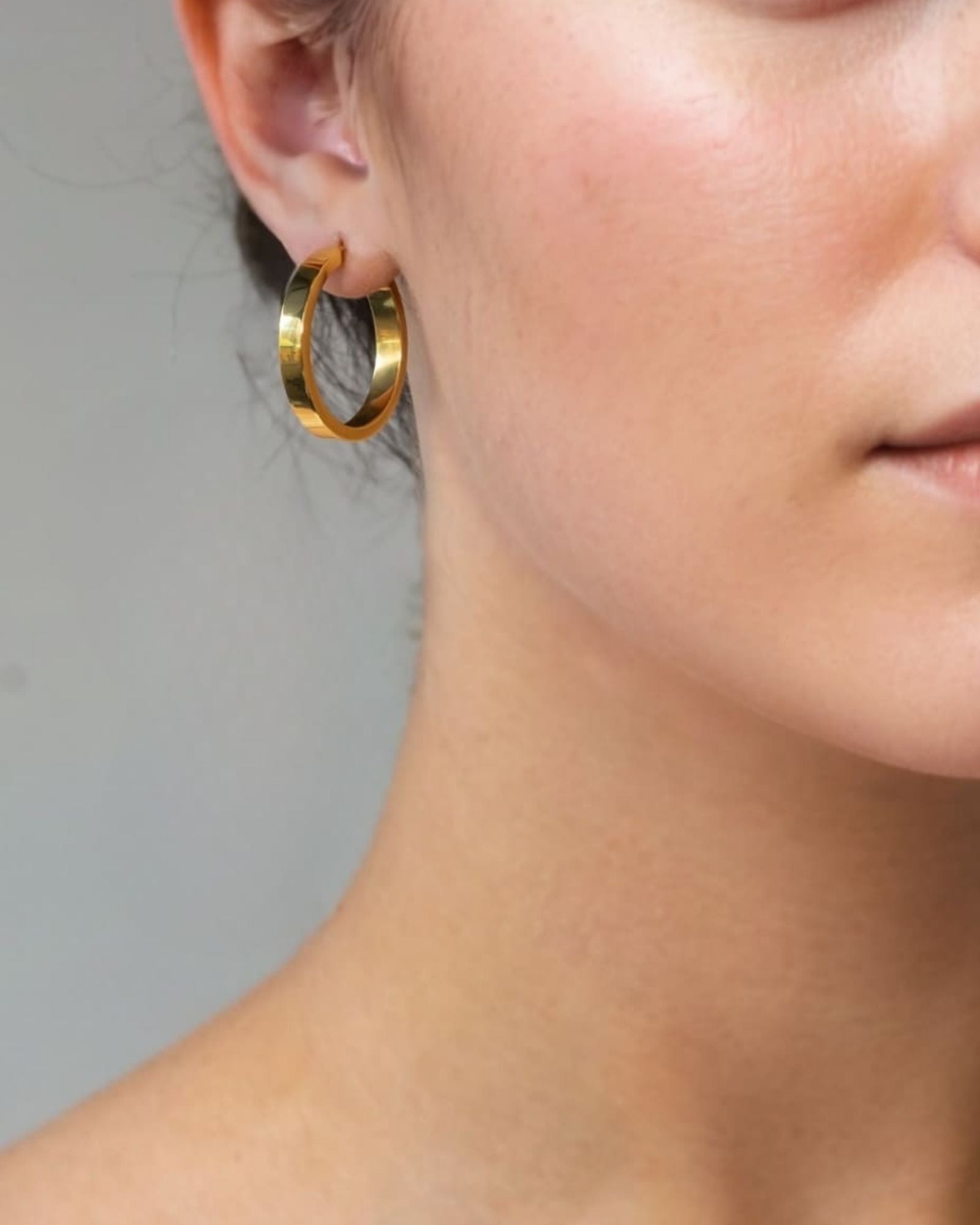 Luna Gold Large Hoop Earrings by Lavana on model polished classic 4mm hoops available in four sizes