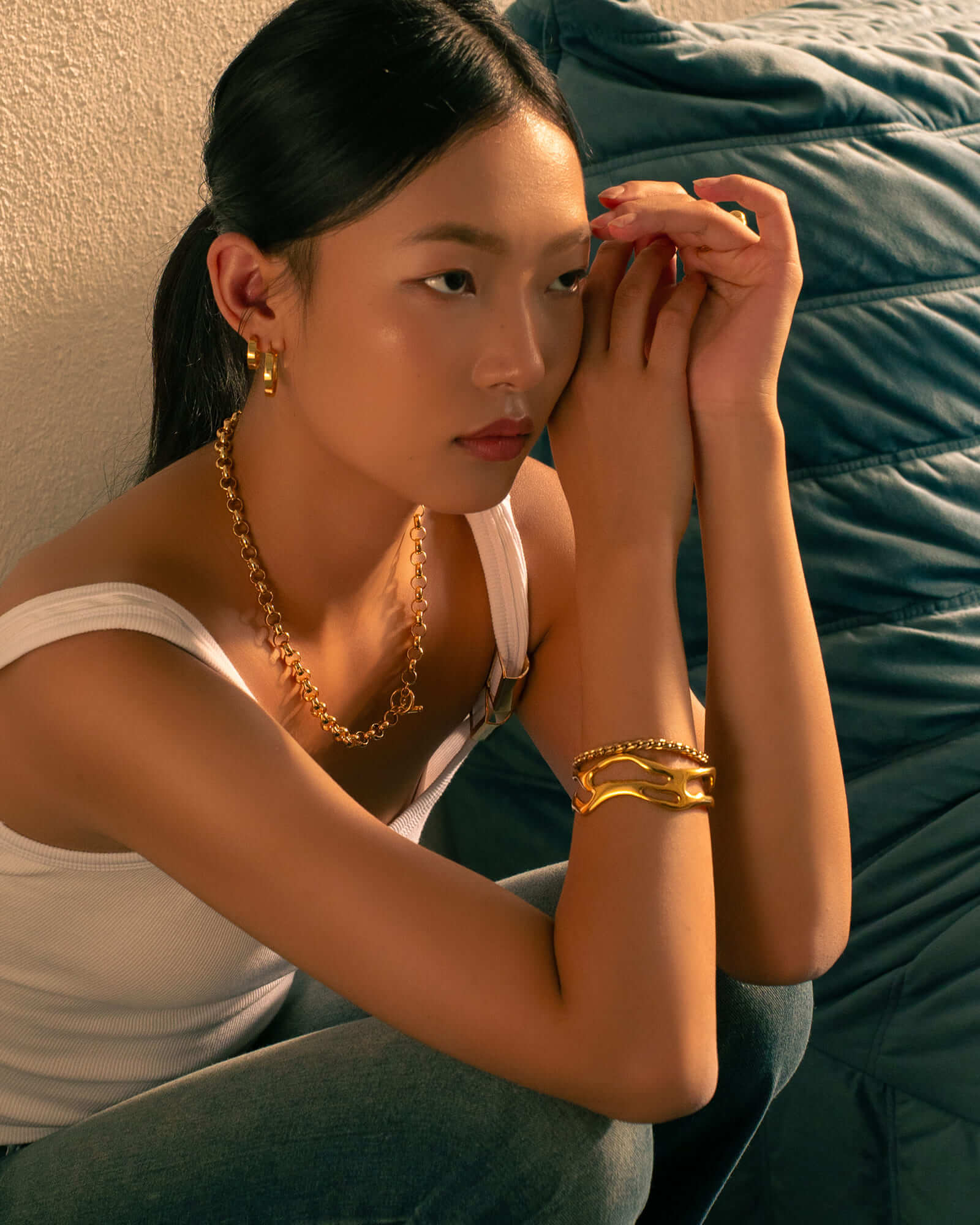 Luna Gold S Hoop Earrings by Lavana, on model; polished classic 4mm dress hoops available in four sizes