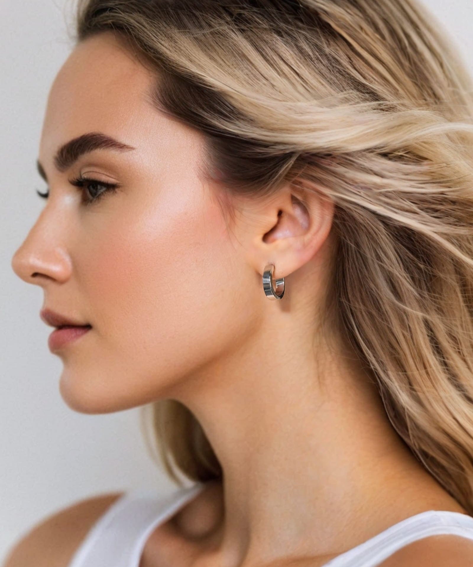 Luna Gold Small Hoop Earrings by Lavana on model polished classic 4mm hoops available in four sizes