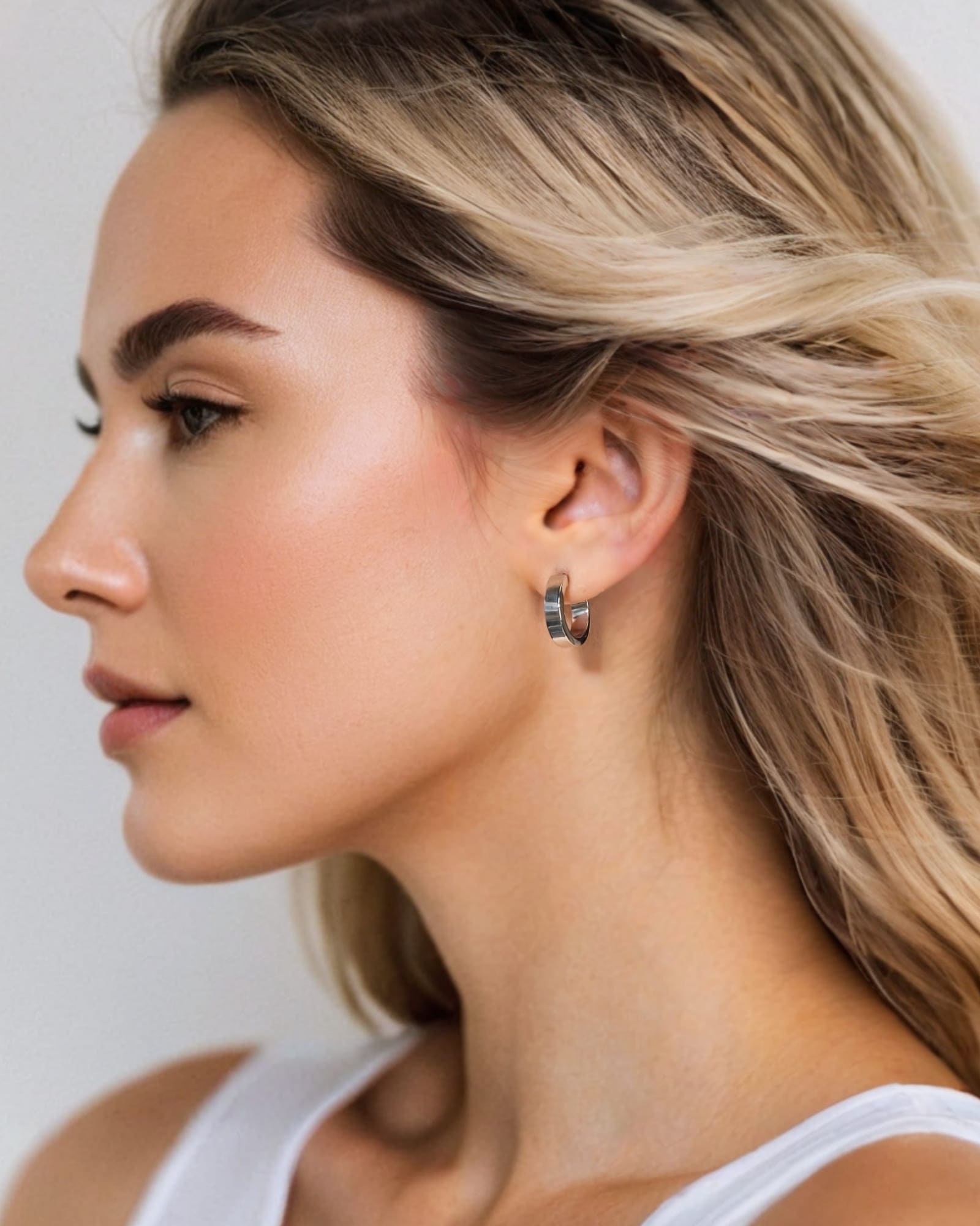 Luna Gold Small Hoop Earrings by Lavana on model polished classic 4mm hoops available in four sizes