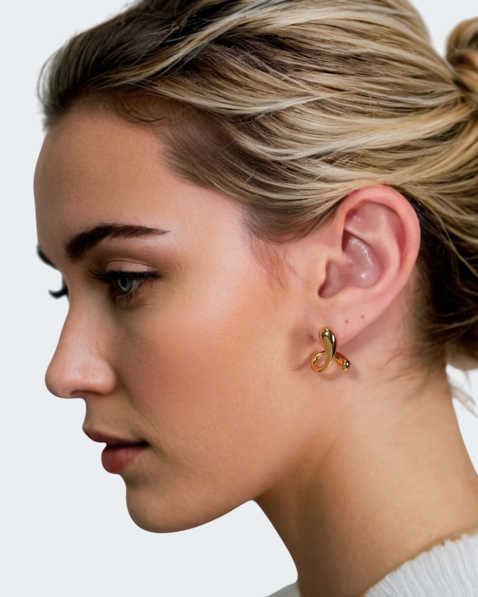 Molten Curve Gold Stud Earrings by Lavana, on model fluid sculptural curved studs 