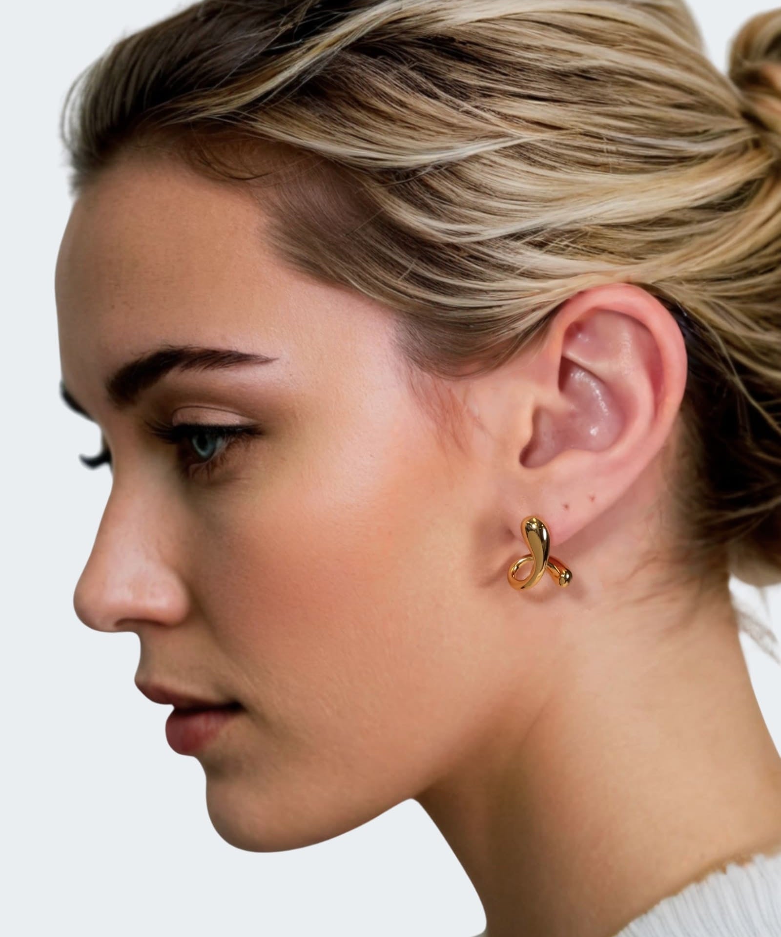 Molten Curve Gold Stud Earrings by Lavana, on model fluid sculptural curved studs 