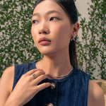 Molten Curve Silver Stud Earrings by LAVANA, on model; polished sculptural curved studs 