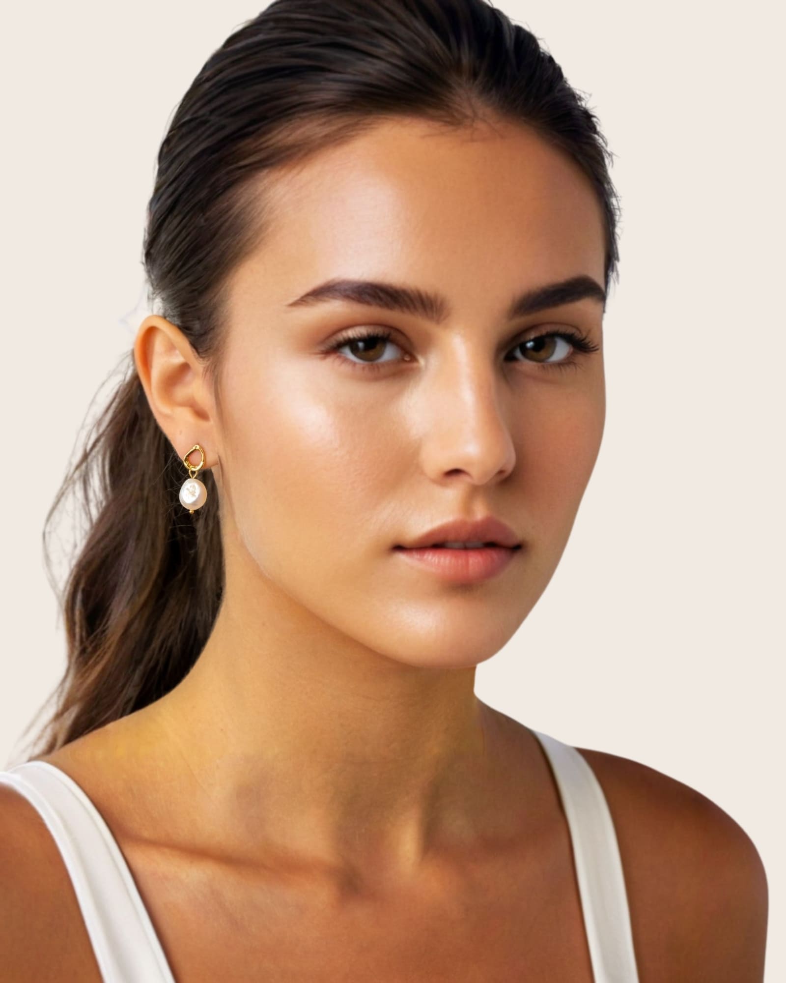 Mondello Gold Pearl Drop Earrings by Lavana, on model; textured organic circle with freshwater pearl drop