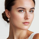 Mondello Gold Pearl Drop Earrings by Lavana on model textured organic circle with freshwater pearl drop