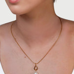 Mondello Gold Pearl Pendant by LAVANA on model with sculptural teardrop and freshwater pearl