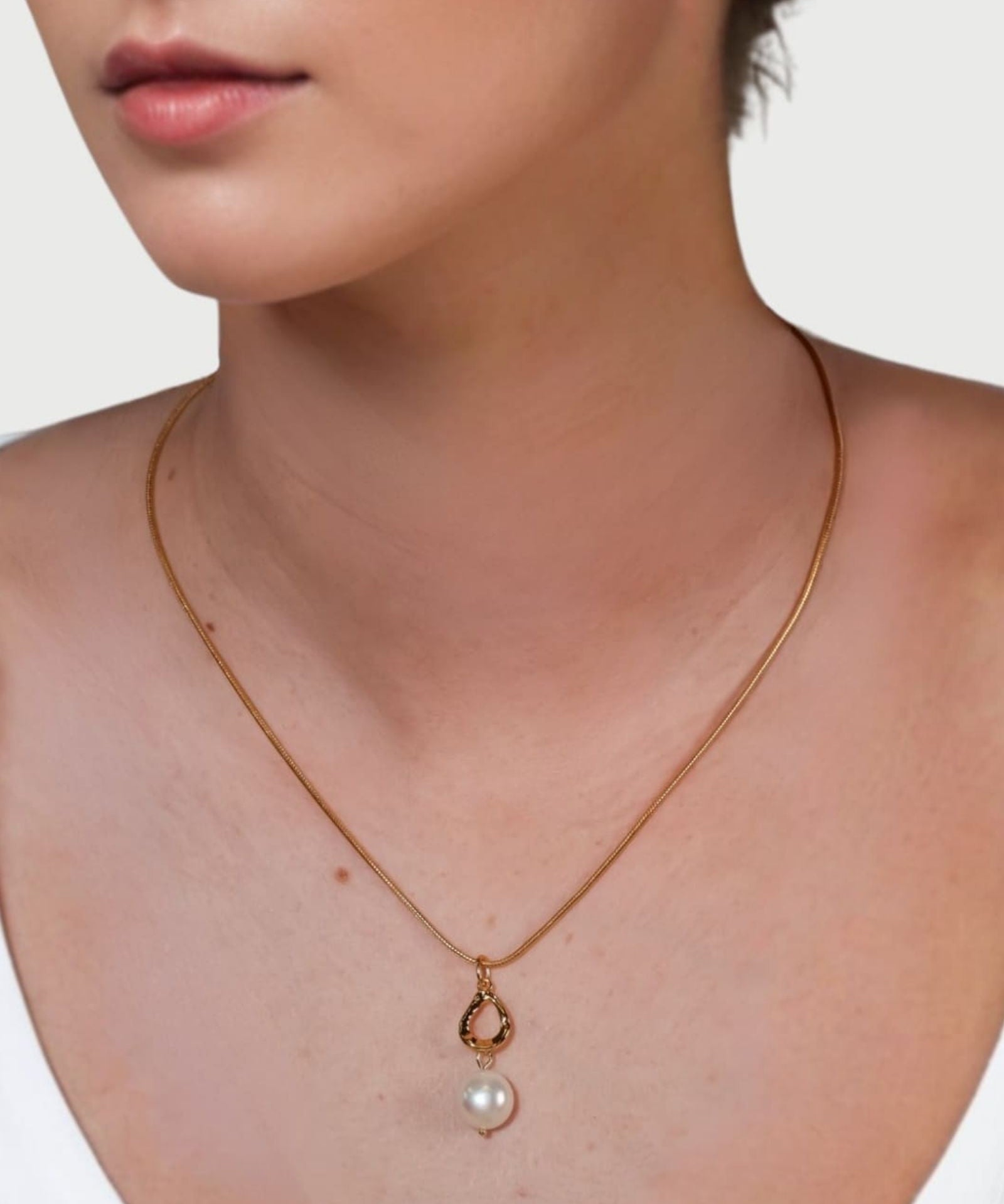 Mondello Gold Pearl Pendant by LAVANA on model with sculptural teardrop and freshwater pearl