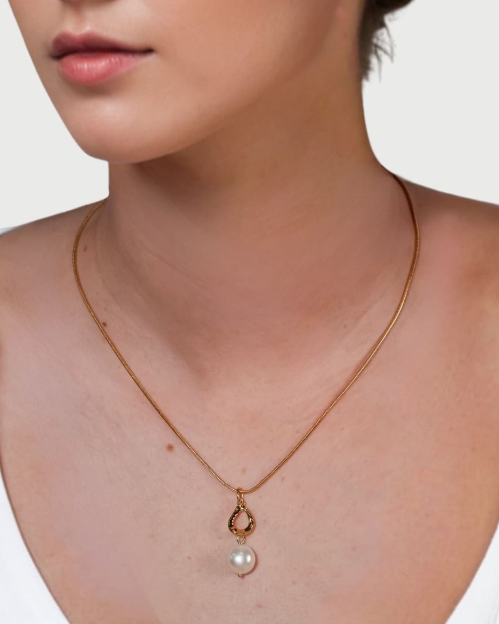 Mondello Gold Pearl Pendant by LAVANA on model with sculptural teardrop and freshwater pearl