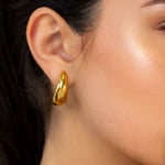 Moonscapes Gold Stud Earrings by LAVANA on model polished chunky crescent dome
