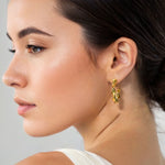 Muse Gold Hoop Earrings by Lavana on model wide hoops with organic twist texture