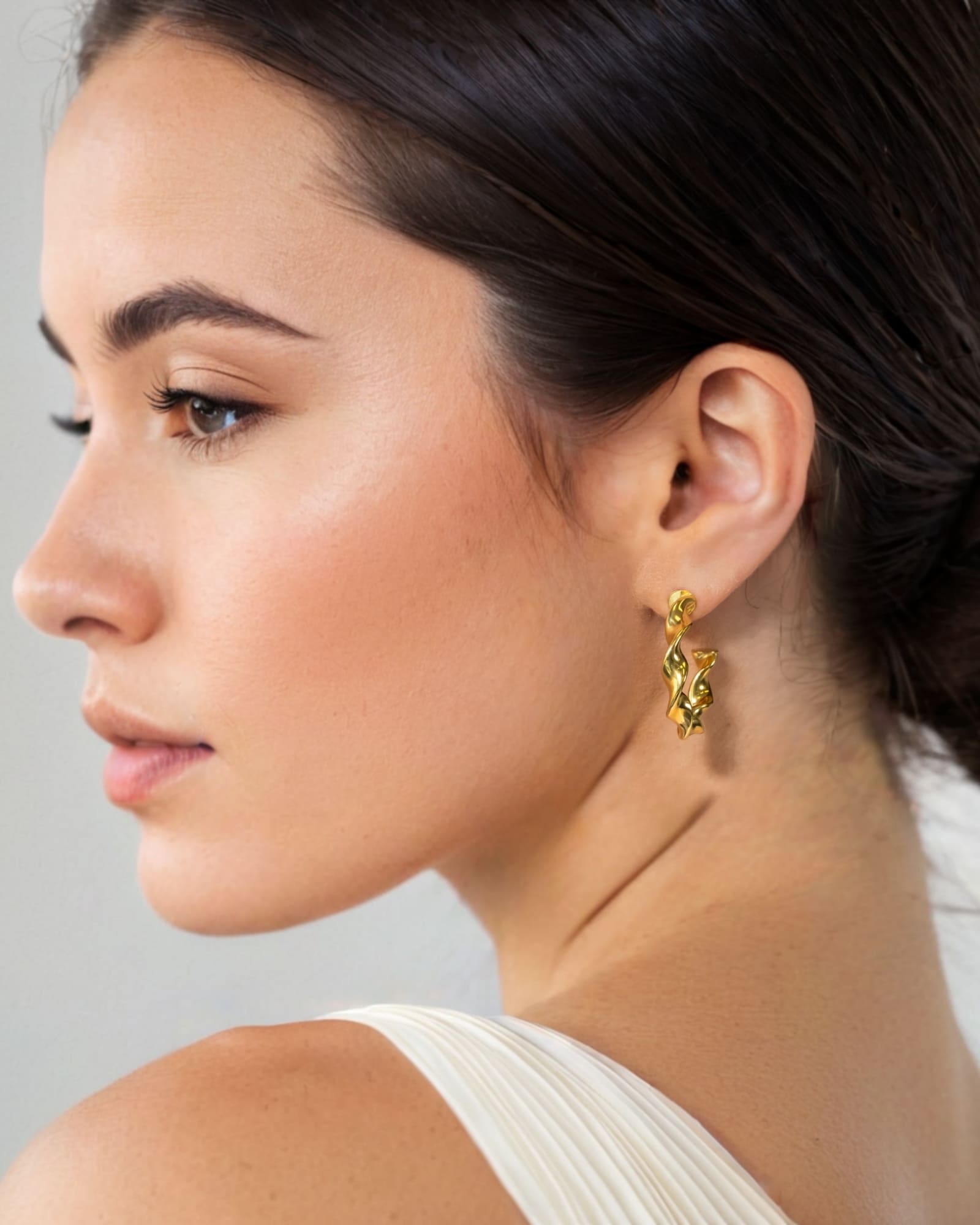 Muse Gold Hoop Earrings by Lavana on model wide hoops with organic twist texture
