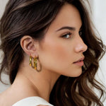 Musica Gold Hoop Earrings Large and Extra Large by Lavana on model large round hoops with fluid twist movement