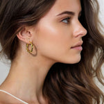 Musica Gold Hoop Earrings Large by Lavana on model large round hoops with fluid twist movement