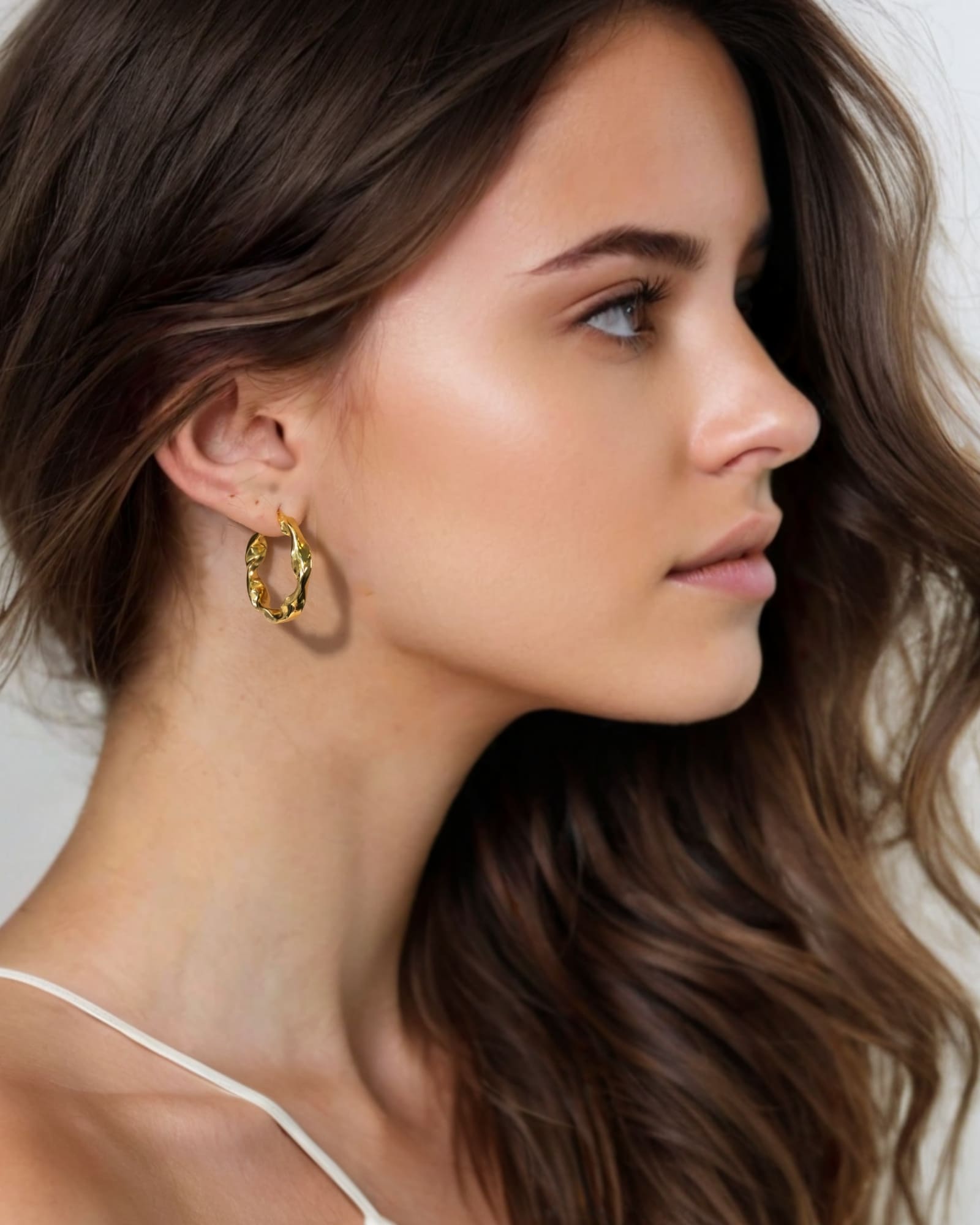 Musica Gold Hoop Earrings Large by Lavana on model large round hoops with fluid twist movement