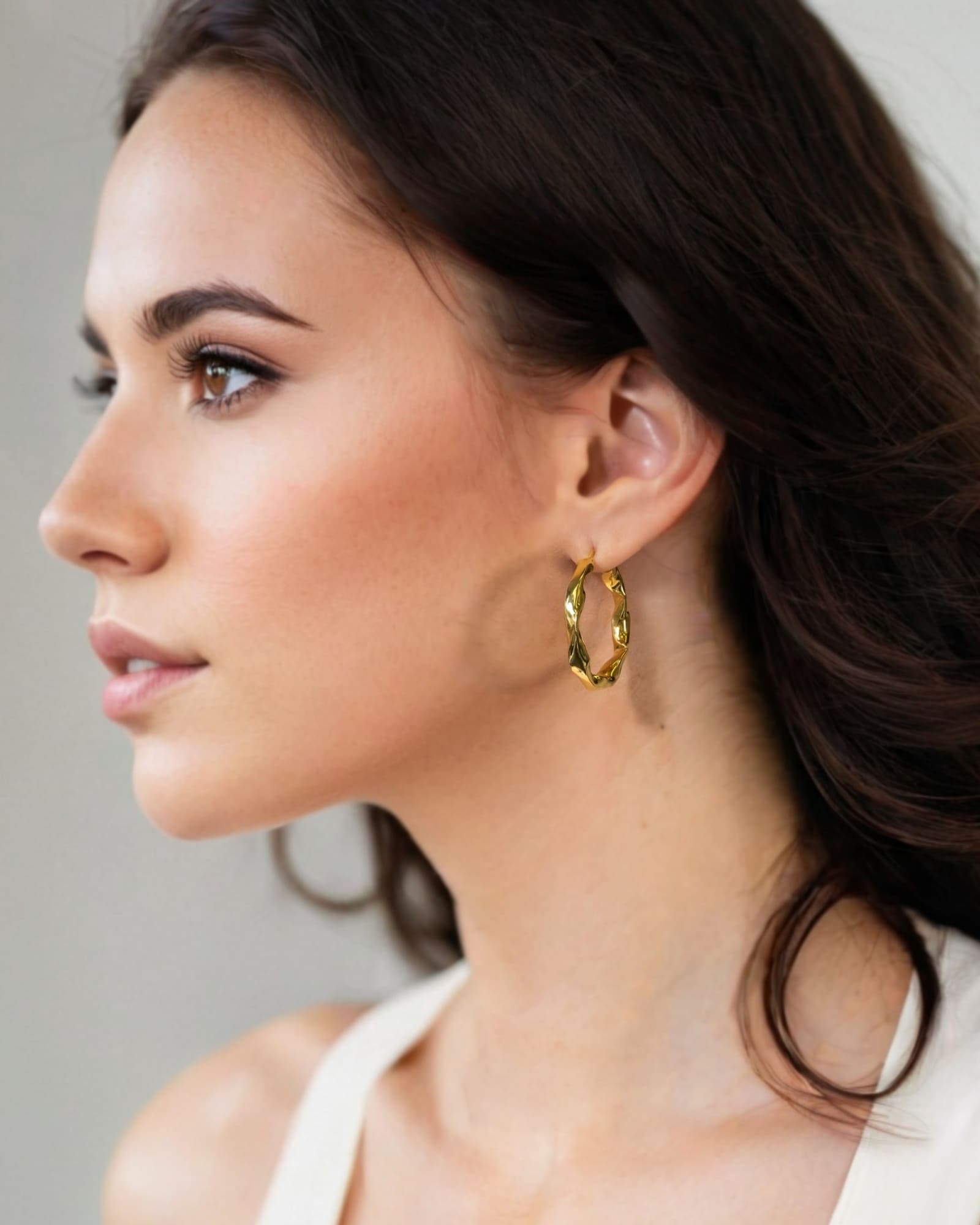 Musica Gold Hoop Earrings by Lavana on model extra large round hoops with fluid twist movement