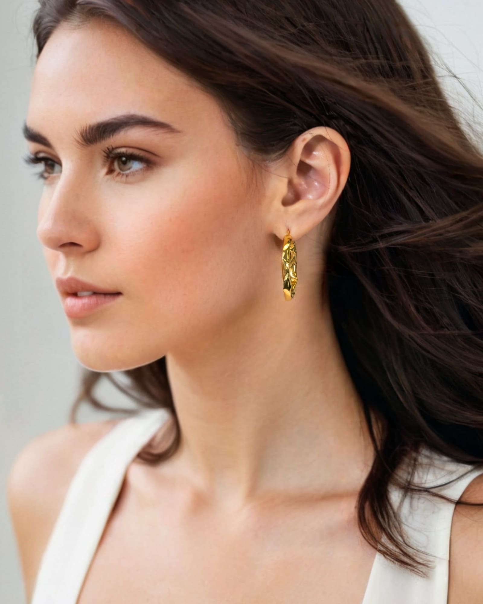 Musica Gold Hoop Earrings by Lavana on model extra large round hoops with fluid twist movement
