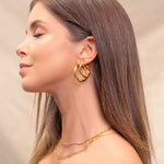 Musica Gold Hoop Earrings by Lavana, on model; large round hoops with fluid twist movement L, XL