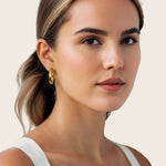 Musica Gold Hoop Earrings by Lavana, on model; large round hoops with fluid twist movement
