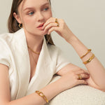 Ocean Whispers Gold Cuff Bracelet by Lavana, on model sculpted wave profile elegant cuff