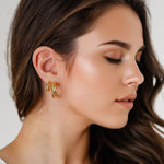 Oceania Gold Hoop Earrings by Lavana on model open back wide hoops with wave ridge texture