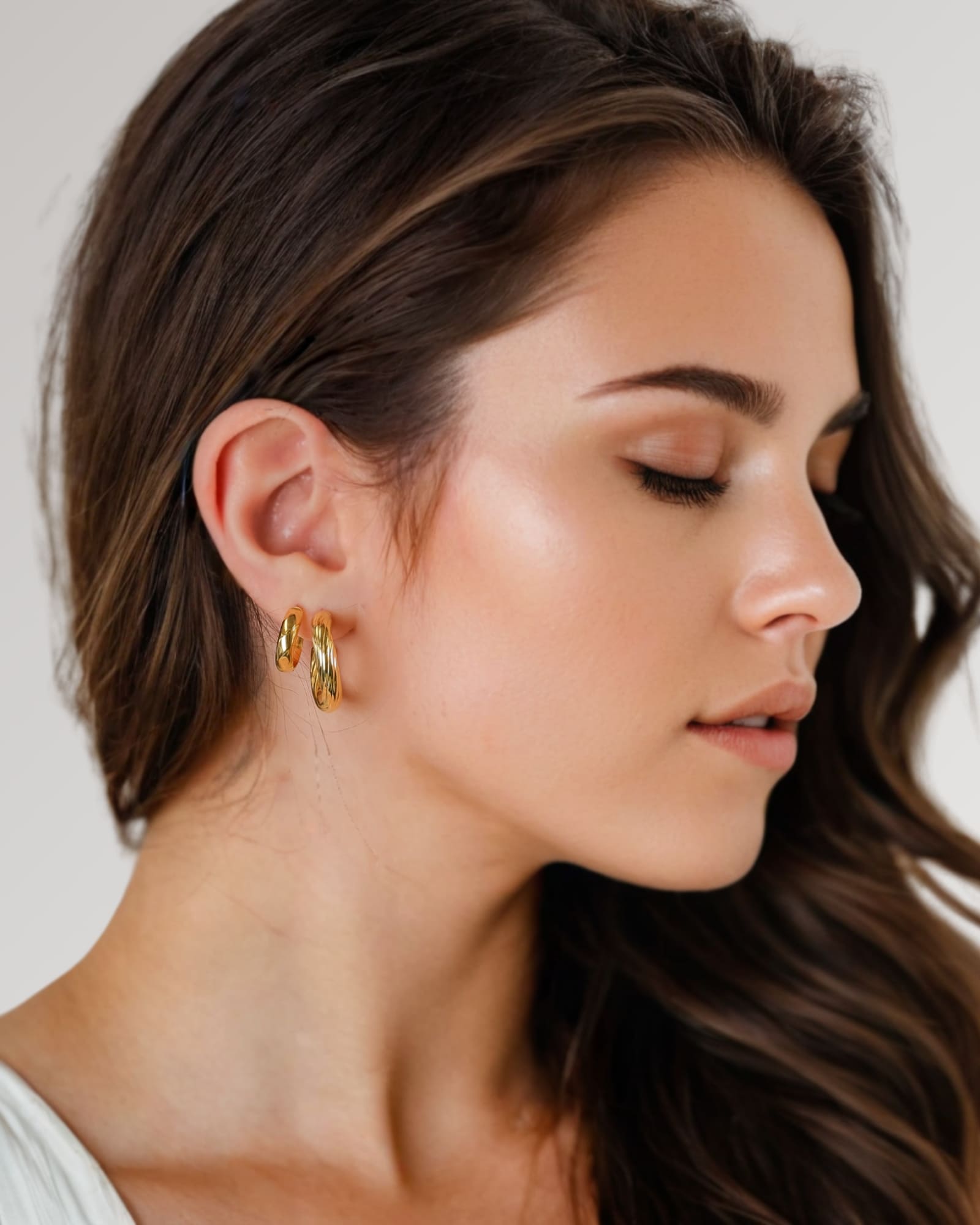 Oceania Gold Hoop Earrings by Lavana on model open back wide hoops with wave ridge texture