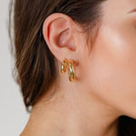 Oceania Gold Hoop Earrings by Lavana on model open back wide hoops with wave ridge texture