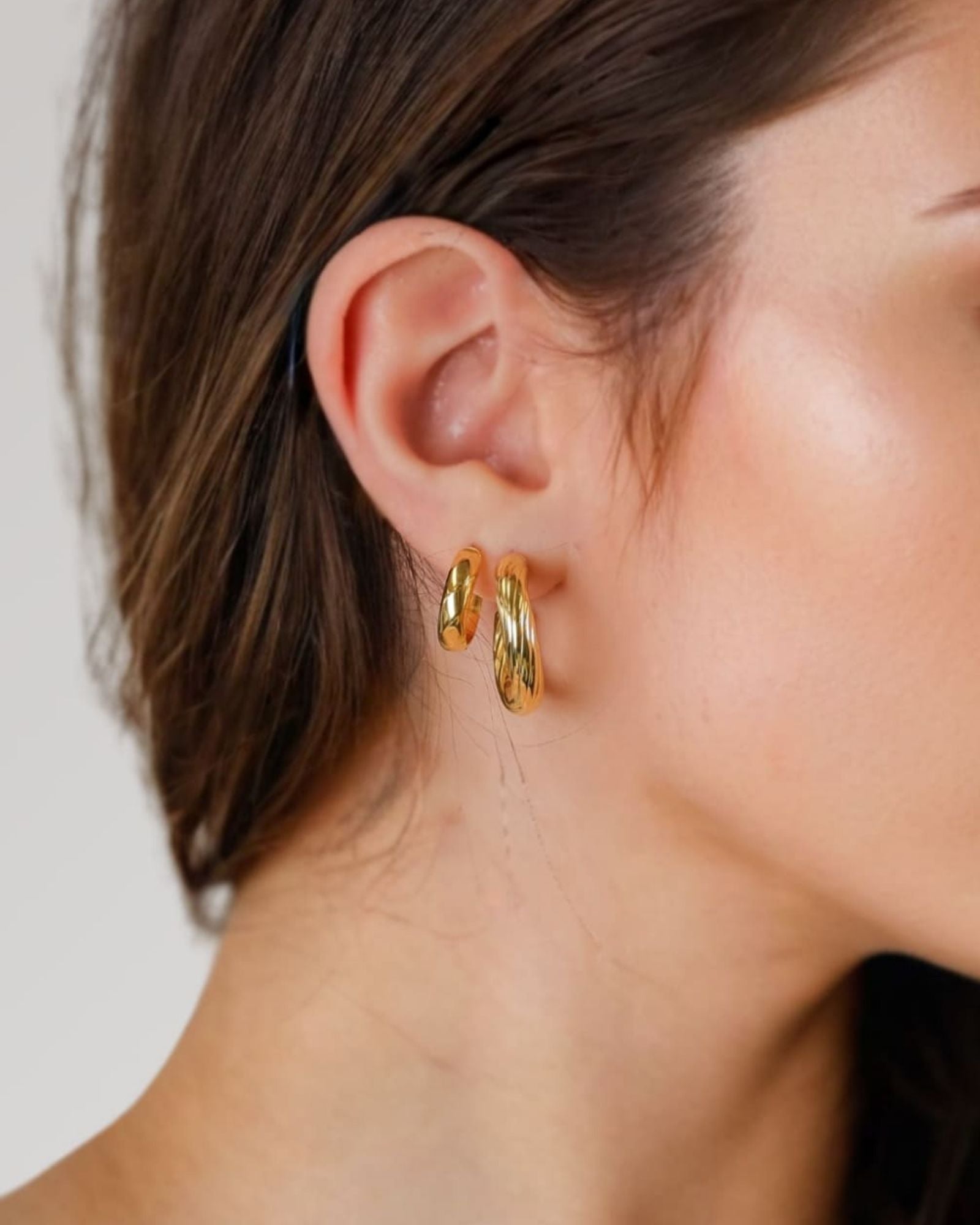 Oceania Gold Hoop Earrings by Lavana on model open back wide hoops with wave ridge texture