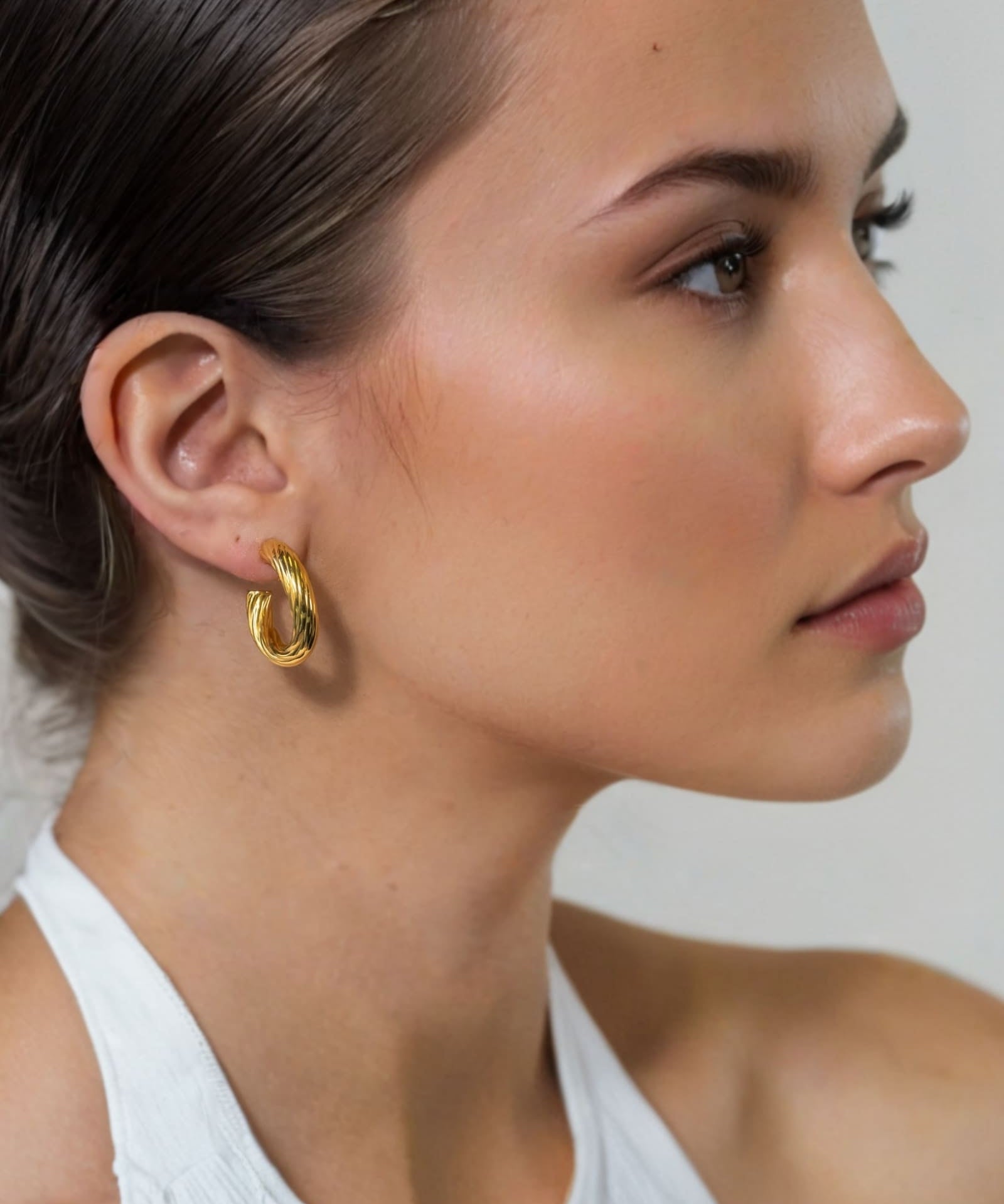 Oceania Gold Hoop Earrings by Lavana on model open back wide hoops with wave ridge texture