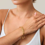 Organic Fluid Gold Bangle by LAVANA on model with smooth sculptural loop design
