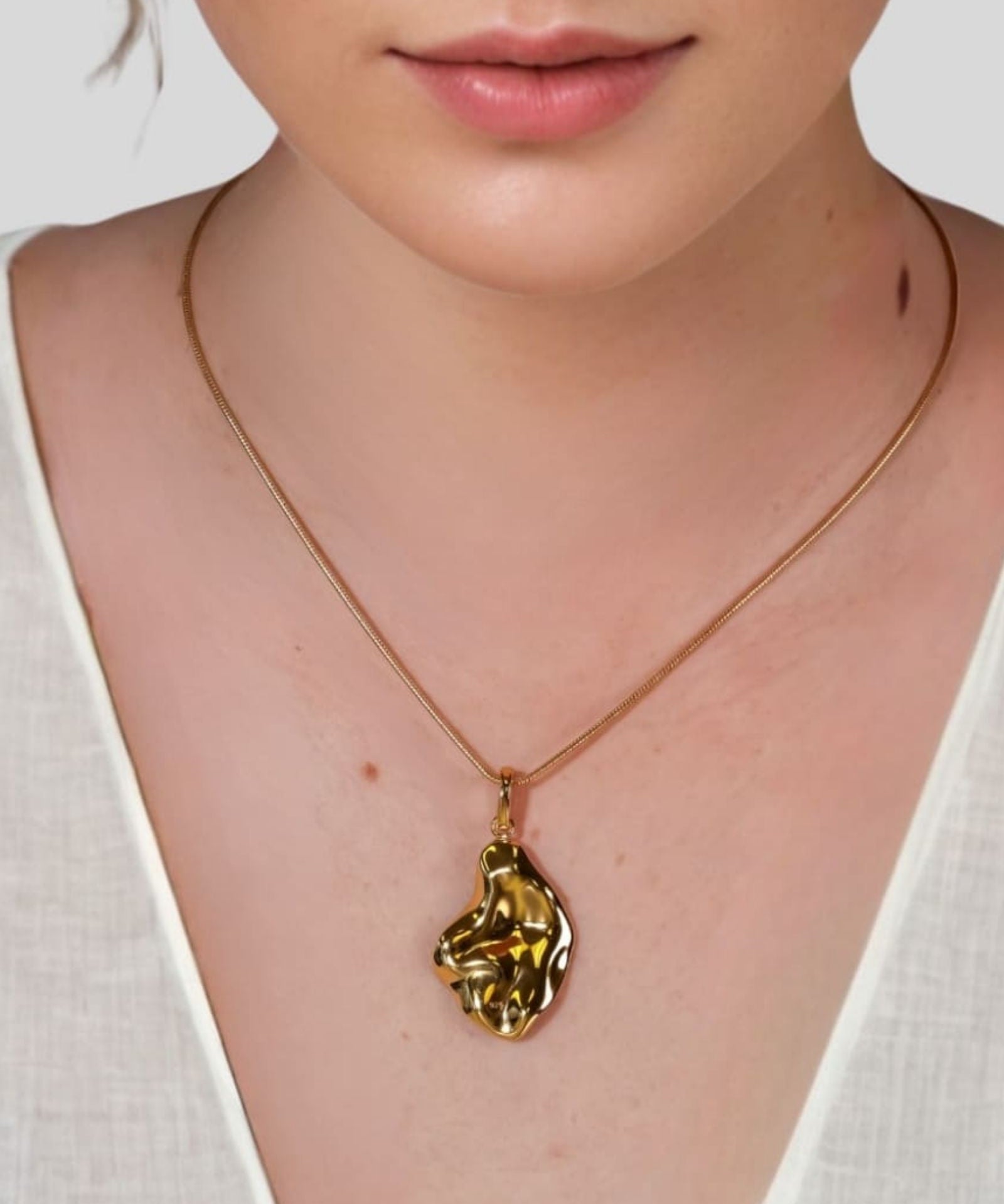 Pearlescent Reversible Gold Pendant by Lavana on model with brushed front and high polish back