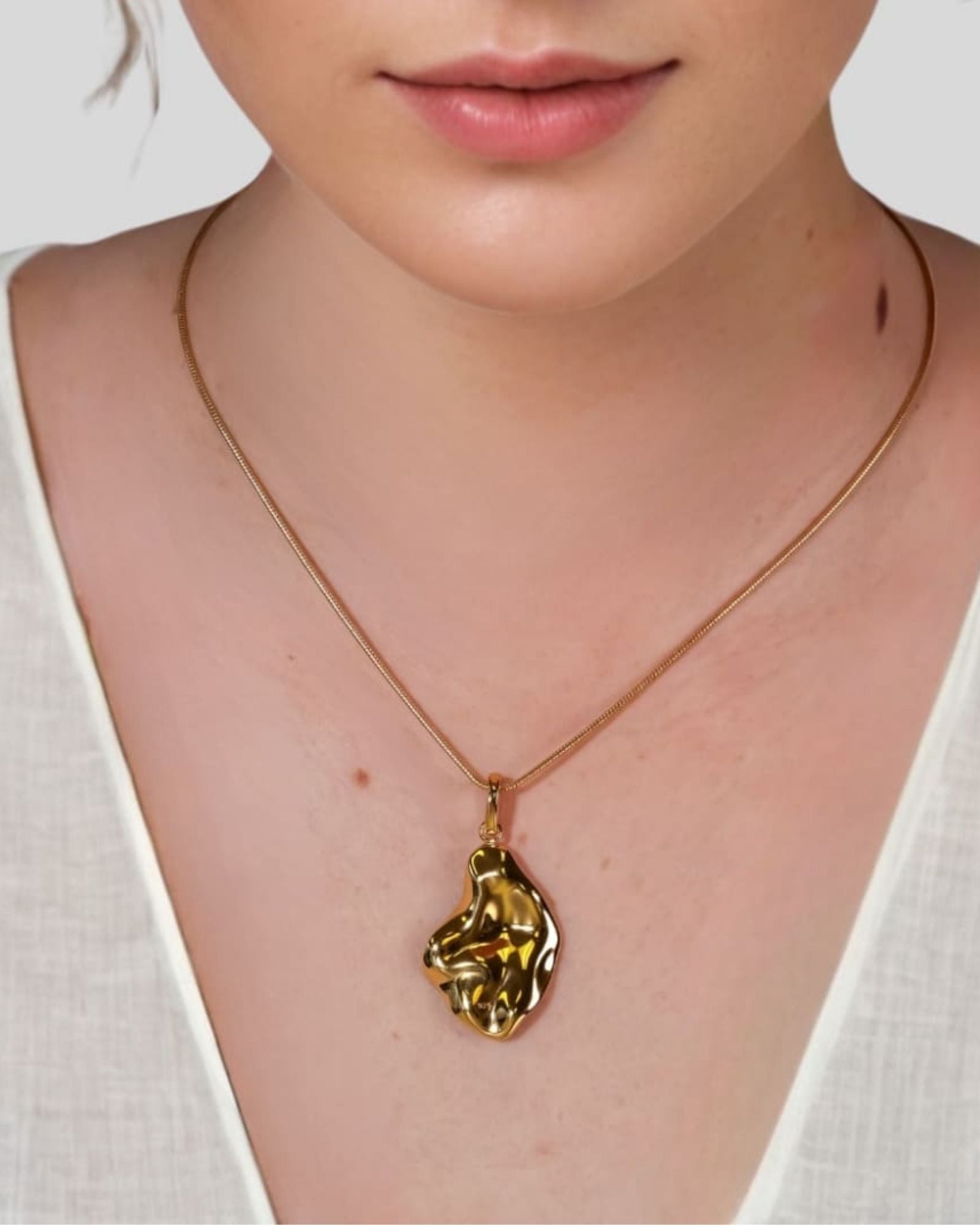 Pearlescent Reversible Gold Pendant by Lavana on model with brushed front and high polish back