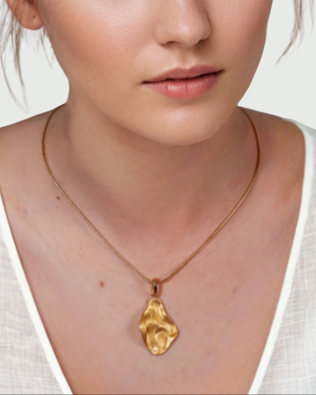 Pearlescent Reversible Gold Pendant by Lavana on model with brushed front and high polish back