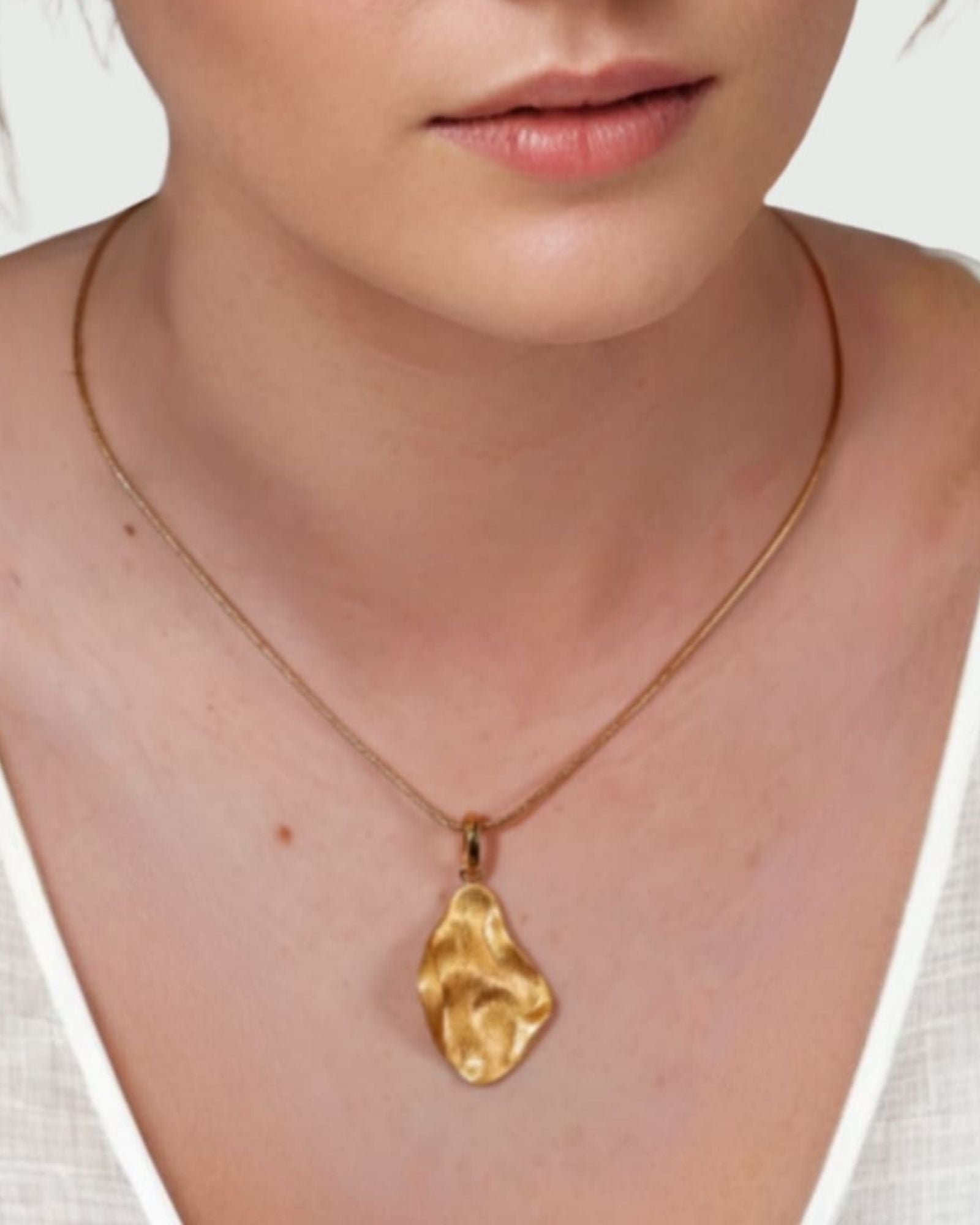 Pearlescent Reversible Gold Pendant by Lavana on model with brushed front and high polish back
