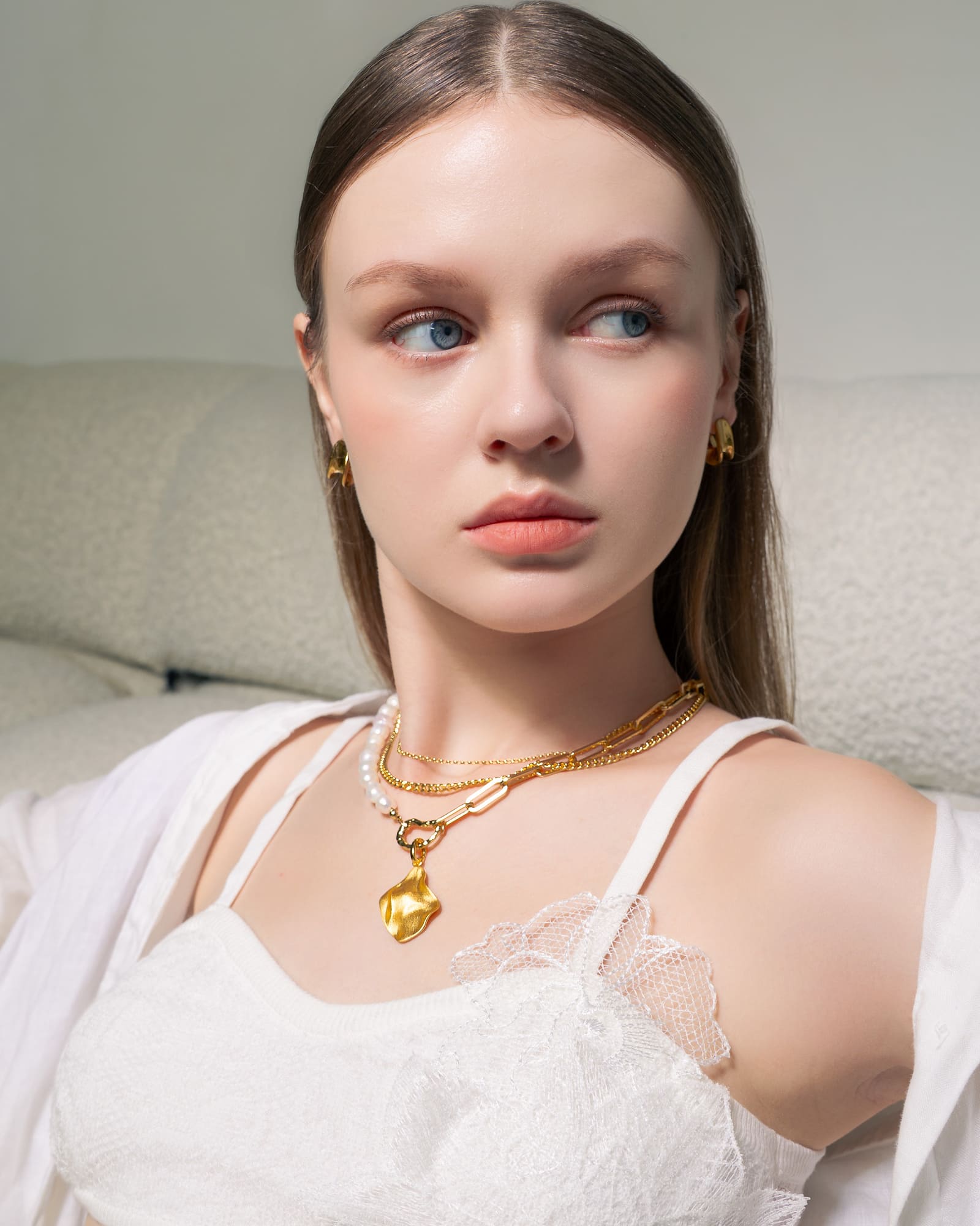 Pearlescent reversible gold pendant by Lavana, on model with modern brushed front and high polish back