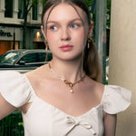 Pebble Pearl Charm Gold Huggie Earrings by LAVANA, on model; classic domed huggies with three freshwater pearl charms