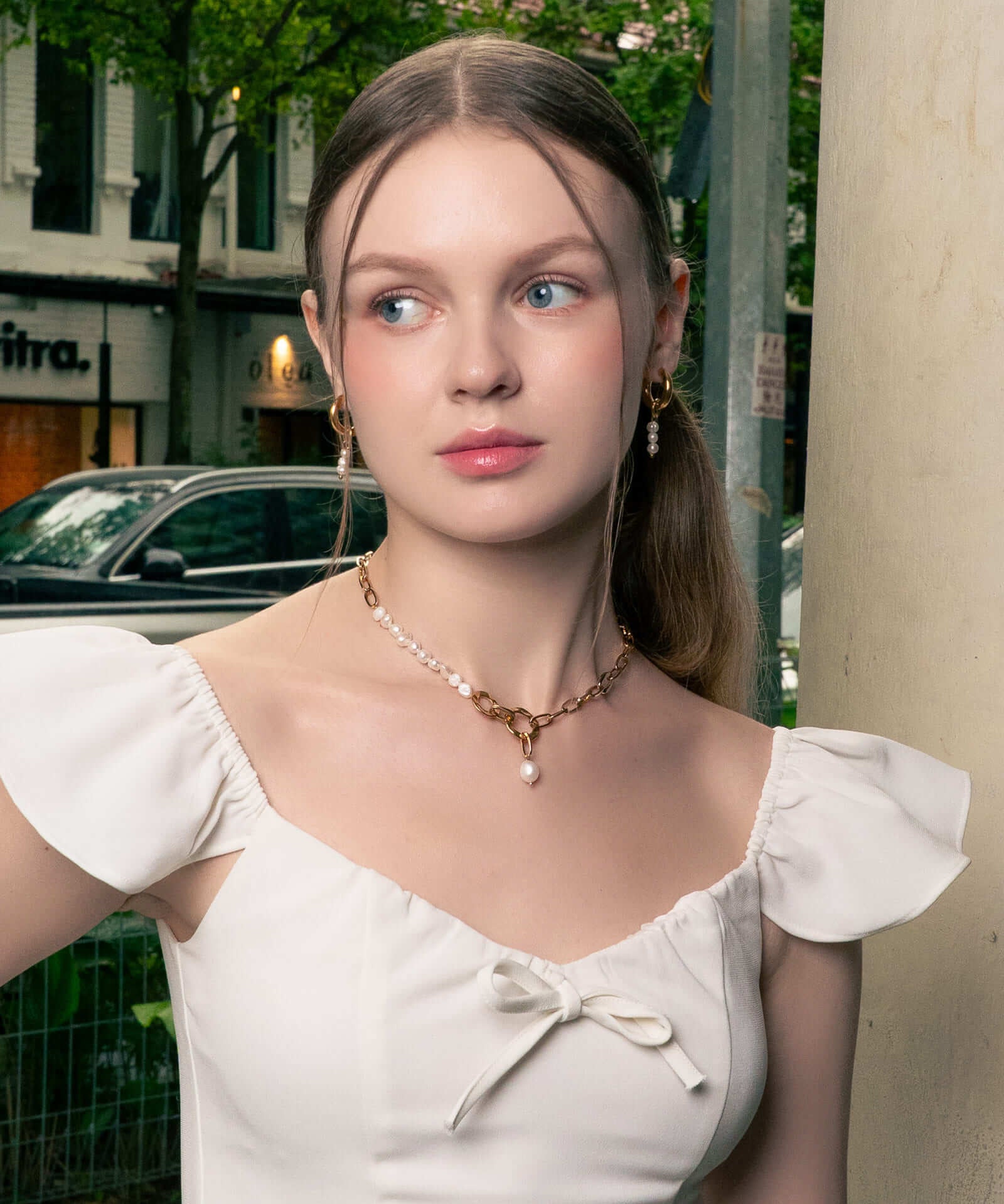 Pebble Pearl Charm Gold Huggie Earrings by LAVANA, on model; classic domed huggies with three freshwater pearl charms